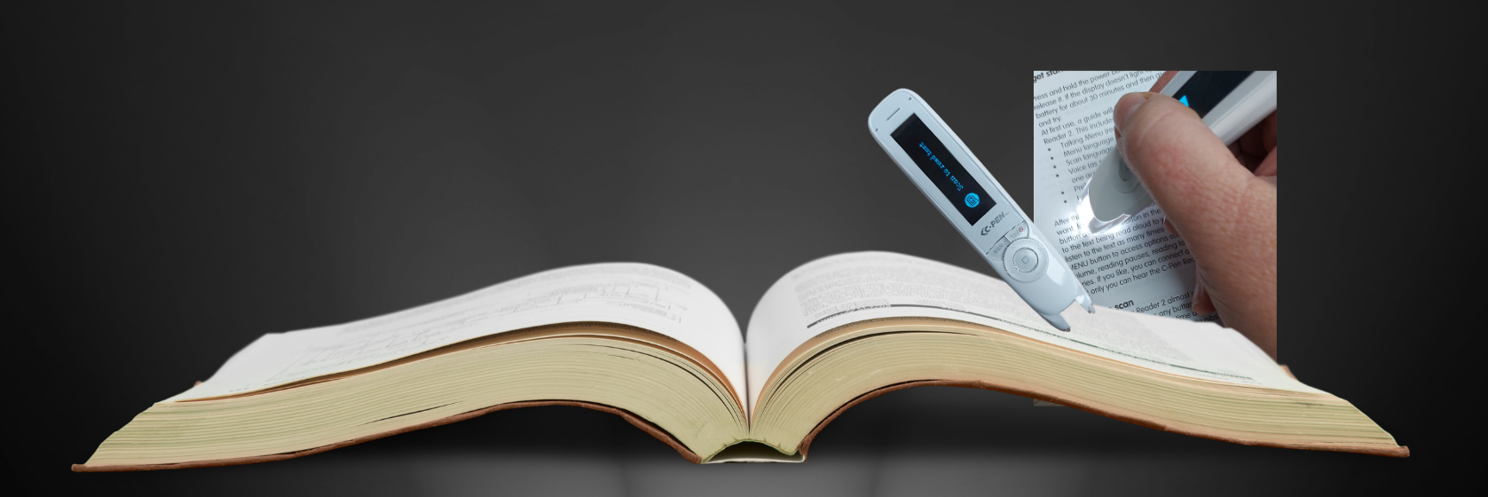 C-Pen text Reader with Book on black background