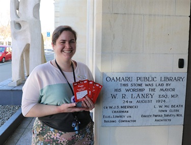 Annie from the library holding Prezzie Cards