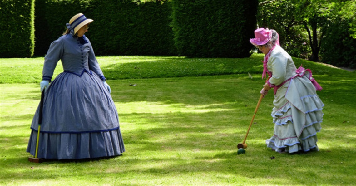 People playing croquet in victorian dress