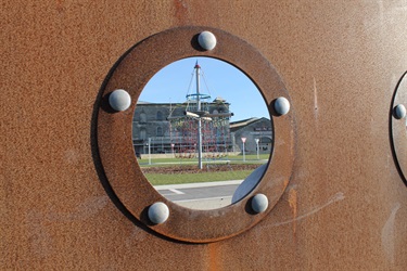 looking through a porthole at play equipment