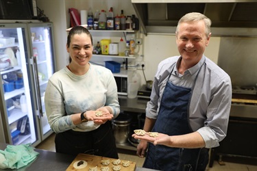 Kat Rivison and Mayor Gary Kircher showing their completed mushroom dumplings